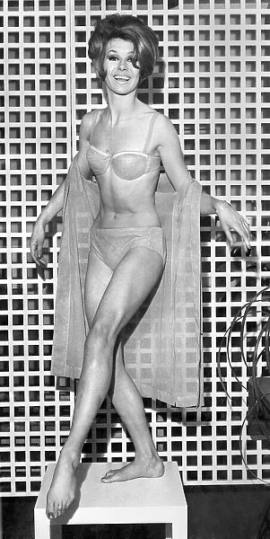 Clothing Beach. Model shows bikini and sheer wrap. March 1963 P017972