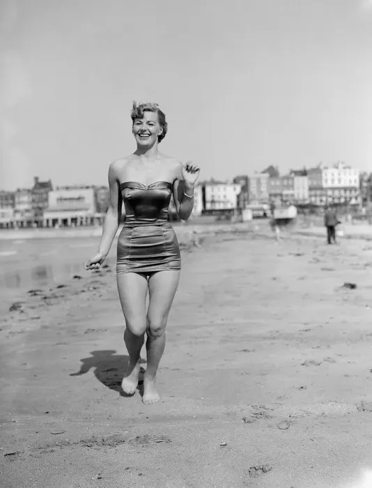 Framed Print : Clothing Beach wear swimsuits fashion April 1952 Model running along beach Framed Print : Clothing Beach wear swimsuits fashion April 1952 Model running along beach