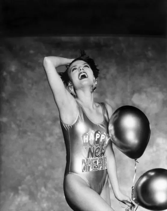 Framed Print : Clothing Beach. Woman models a shiny swimming costume with Happy New Year