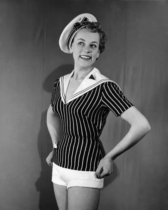 Framed Print : Clothing Beachwear. Model wears sailors hat, striped fitted naval style top Framed Print : Clothing Beachwear. Model wears sailors hat, striped fitted naval style top