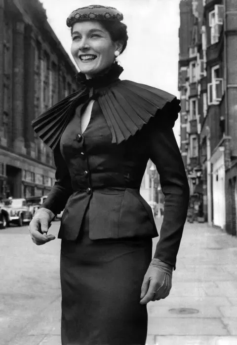 Framed Print : Clothing Fashion 1955: A black pure silk suit with small pleated detachable ruff cape of Framed Print : Clothing Fashion 1955: A black pure silk suit with small pleated detachable ruff cape of