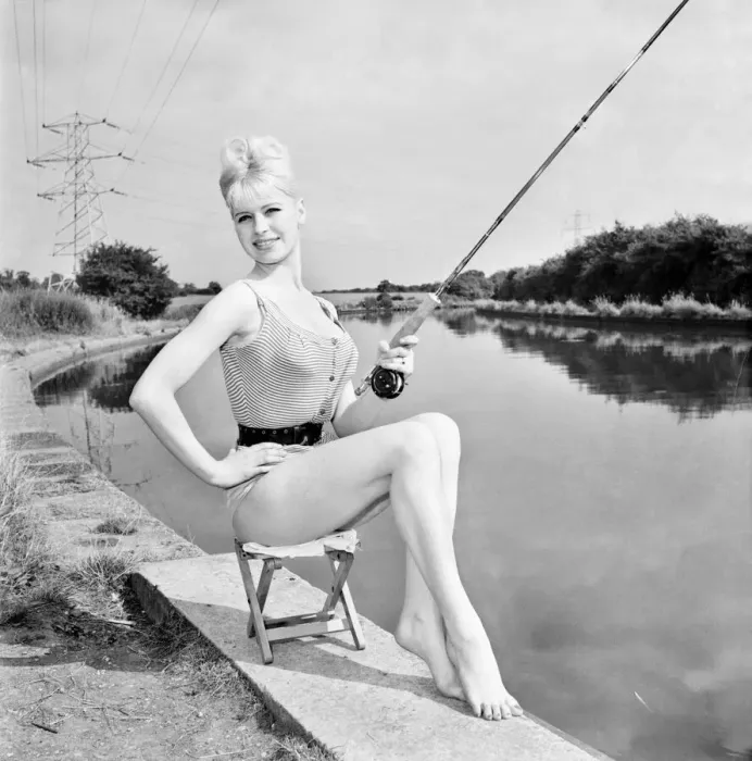 Framed Print : Clothing: Fashion: Beachwear: Model by the river bank fishing. August 1963 E490-013 Framed Print : Clothing: Fashion: Beachwear: Model by the river bank fishing. August 1963 E490-013