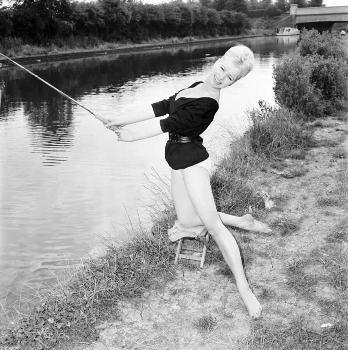 Framed Print : Clothing: Fashion: Beachwear: Model by the river bank fishing. August 1963 E490-008 Framed Print : Clothing: Fashion: Beachwear: Model by the river bank fishing. August 1963 E490-008
