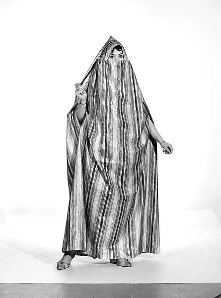Clothing: Fashion: Beachwear: Woman wearing beach dress. 1963