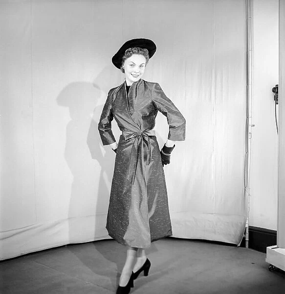 Clothing: Fashion: Coats. Woman wearing full length coat. 1956 B133