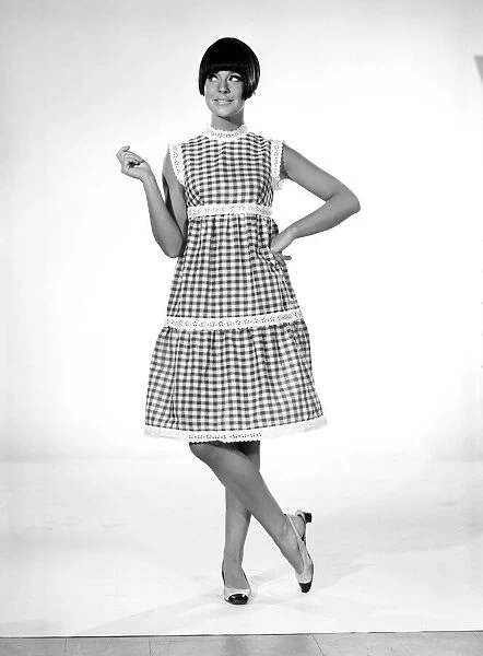 Clothing: Fashion: Dress: Woman wearing gingham dress. 1966