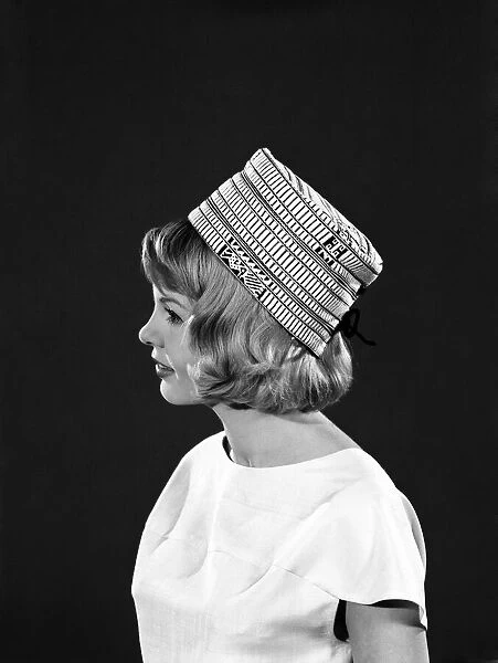 Clothing: Fashion: Hats: Model: Elizabeth Duke. August 1962 B1499-004