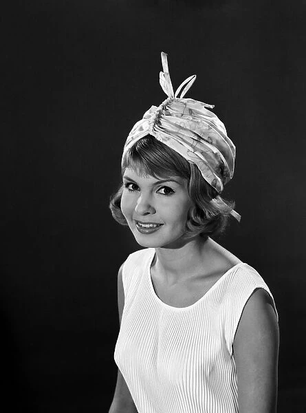 Clothing: Fashion: Hats: Model: Elizabeth Duke. August 1962 B1499