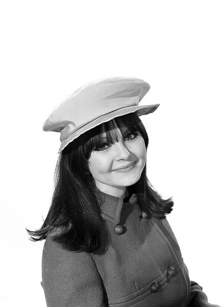 Clothing: Fashion: Hats. Model: Joanne Young. 1966 B2077-001