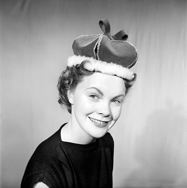 Clothing: Fashion: Hats: Woman wearing crown hat. 1958 B118-001
