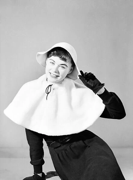 Clothing: Fashion: Hats: Woman wearing matching cape and hat. 1957 B261