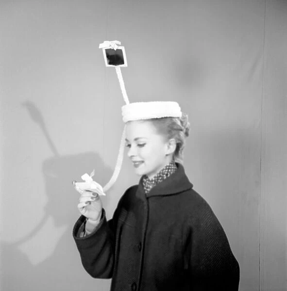 Clothing: Fashion: Hats. Woman wearing periscope hat. 1953 B140
