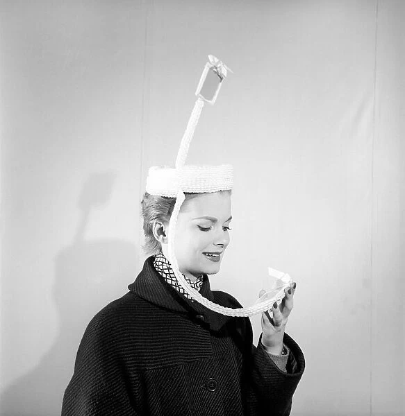 Clothing: Fashion: Hats. Woman wearing periscope hat. 1953 B140-002