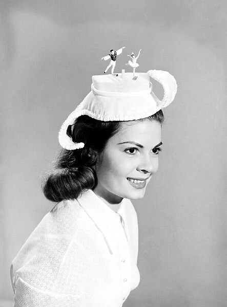 Clothing: Fashion: Hats: Woman wearing unusual hats. 1955 B277