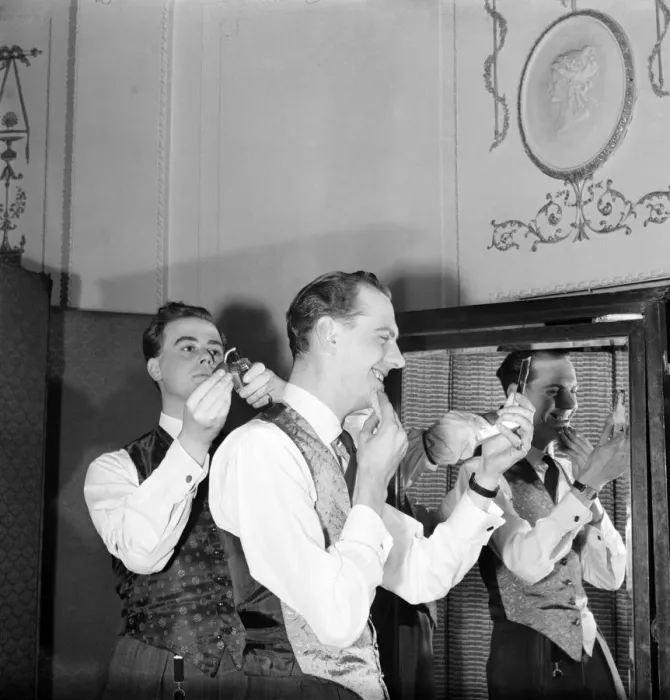 Framed Print : Clothing: Fashion: Men. Two of the male mannequins preparing themselves for the first