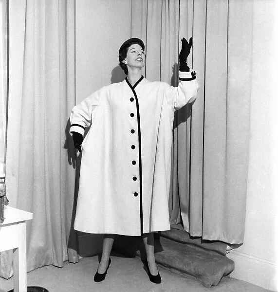 Clothing: Fashion. Model Dorothy Emms wears a white woollen coat with black trim
