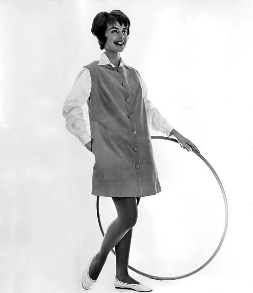 Clothing Fashion. Model wearing dress and holding a hula hoop. December 1958 P006893