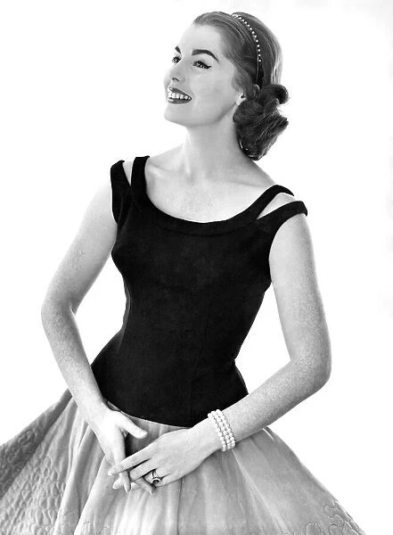 Clothing Fashion: Model wearing a vest and skirt combination. Febuary 1959 P006930