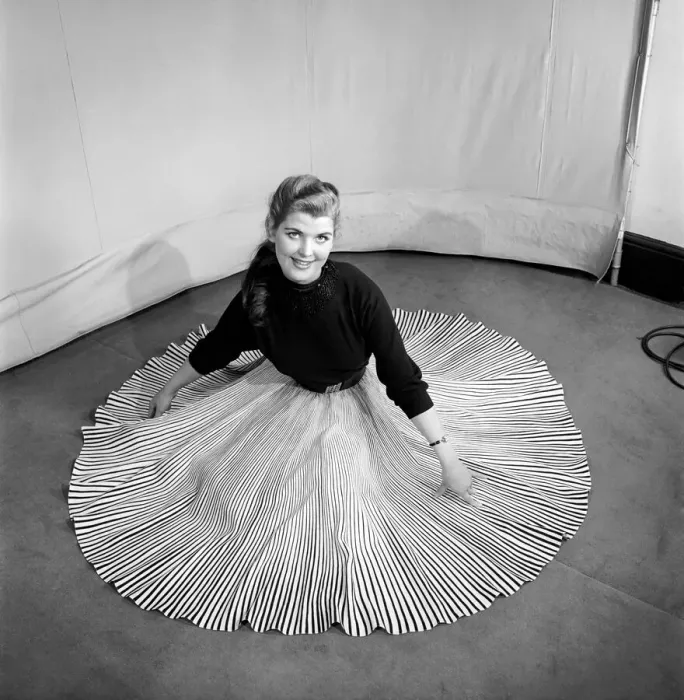 Framed Print : Clothing: Fashion: Skirts: Woman wearing pleated skirt. 1953 B127-001