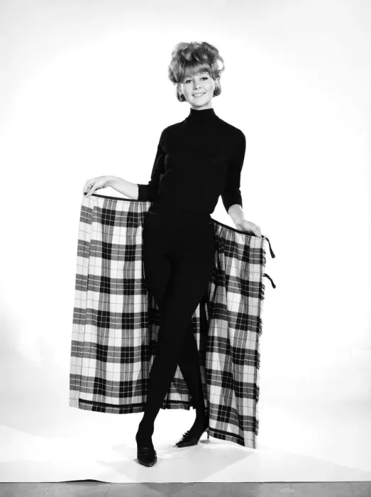 Framed Print : Clothing: Fashion: Skirts: Woman wearing tartan kilt. Model: Pamela Rowe. 1964 B1843-001
