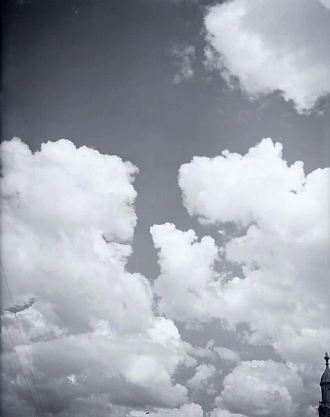 Clouds drift lazily over London on a summeres afternoon in 1941