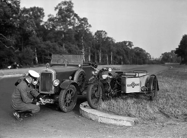 A Clyno car being repaired by an a patrol man. 1932