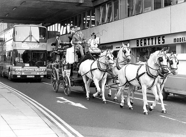 A coach and horse team driving through Newcastle city centre to advertise a new Clipper