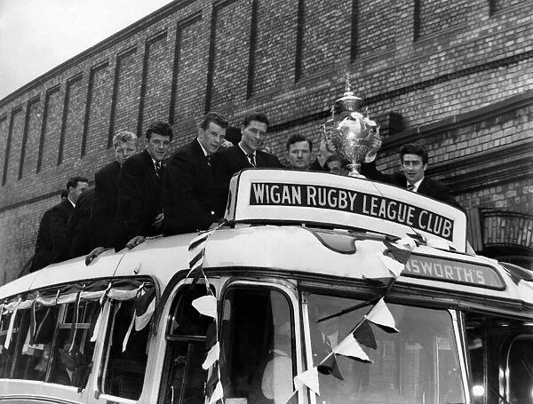 As the coach stops outside the Town Hall at Wigan, the crowd gives a mighty cheer