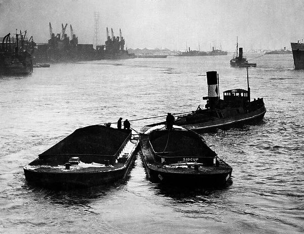 Coal arriving by boat iat a dockyard. February 1947 P017677