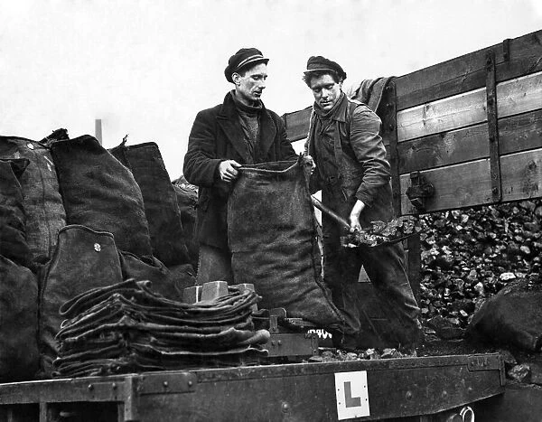 Coal Men filling bags with coal imports from America. December 1954 P005126