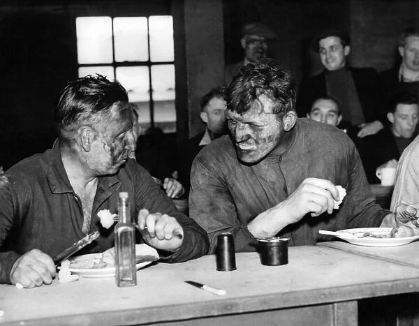 Coal miner Joe Baksi (right) has a canteen lunch after a trip down the pit with Laurence