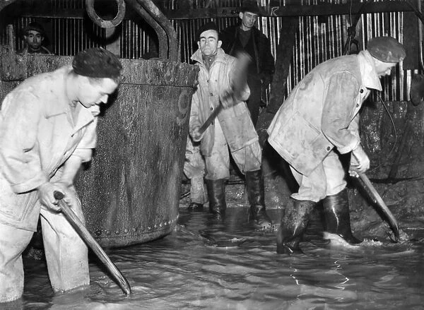 Coal Mines under ground scenes: Workers at a pit in Manchester shovelling out coal