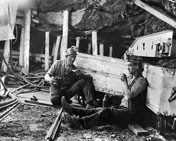 Coal Mines underground scenes. Workers having a break. December 1937