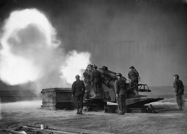 A coastal crew operating a 9. 2 howitzer gun in action on the coast of England during