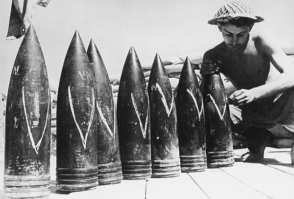 Coastal defence guns of Tobruk. (Picture) Victory being marked on the shells in