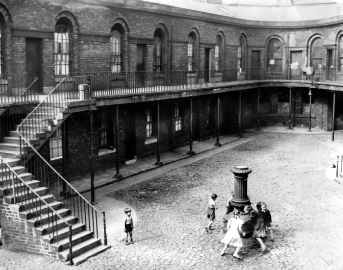 Framed Print : In the cobbled courtyard children play round the old lamp standard in Victoria Market