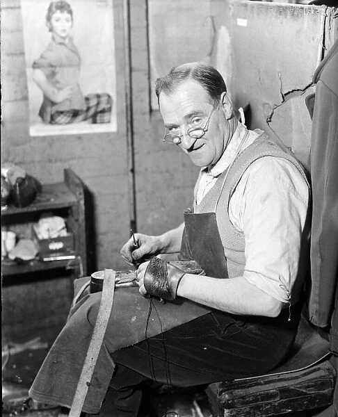 A cobbler at the Mansfield shoe factory in Northampton, hand stitching a pair of shoes