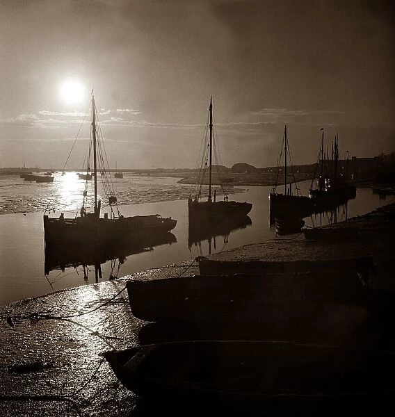 Cockling boats tied up on a river estuary in England circa 1950s
