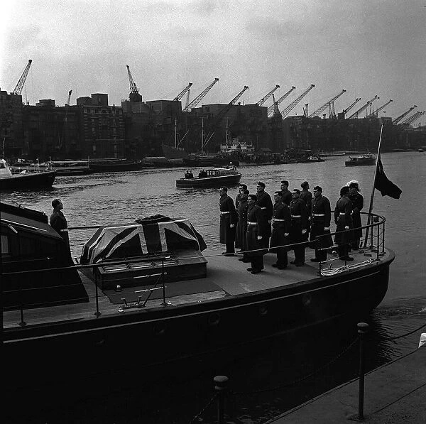 The coffin of Sir Winston Churchill on a barge, travelling down the River Thames during