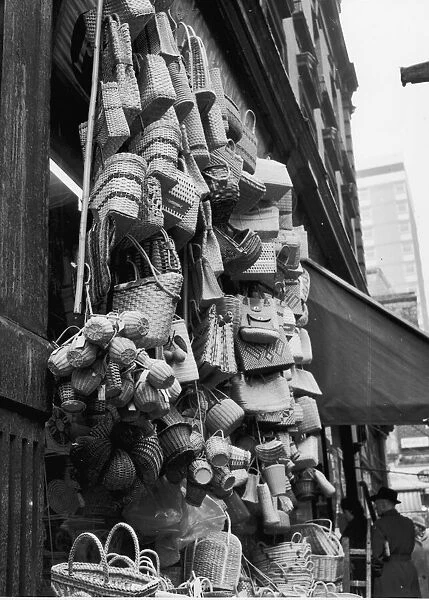 A collection of wicker bags and baskets for sale in Rupert Street, Soho. Circa 1955