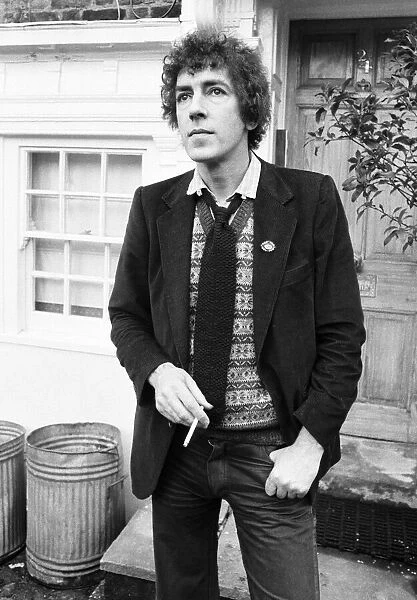 Comedian and actor Peter Cook smoking a cigarette. 25th March 1979