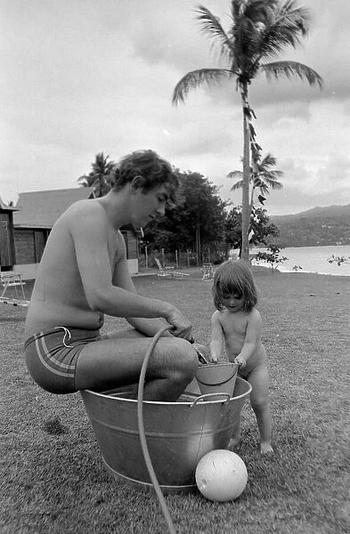 Comedian, actor and publisher Peter Cook with his daughter Lucy during a holiday in