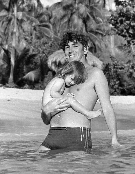 Comedian, actor and publisher Peter Cook with his daughter Lucy during a holiday in