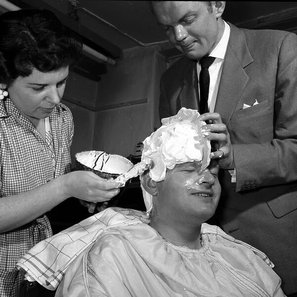 Comedian Benny Hill having a plaster cast of his skull made