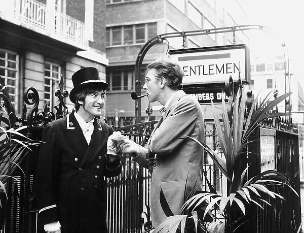 Comedian Peter Cook stands in Carnaby Steet during the filming of sketch for
