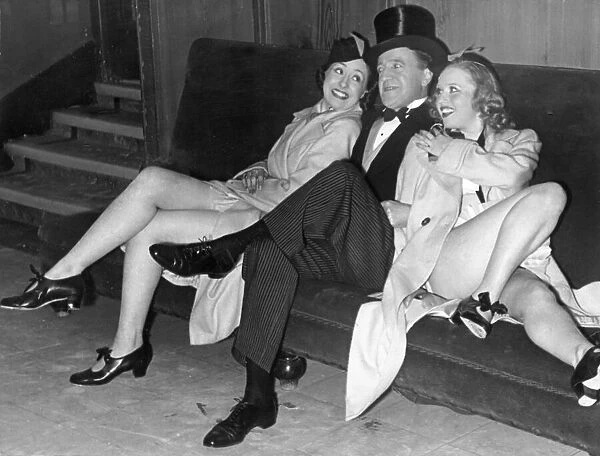 Comedian Tommy Handley with two modern girl secretaries at Jack Hylton