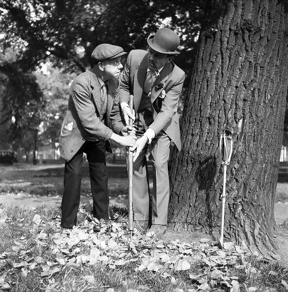 Comic actor Terry Thomas in Hyde Park with a park keeper. October 1953 D5972-1