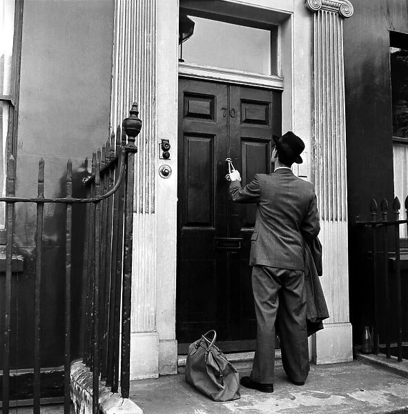 Coming Home: Father returning home from a business trip. September 1953 D5887