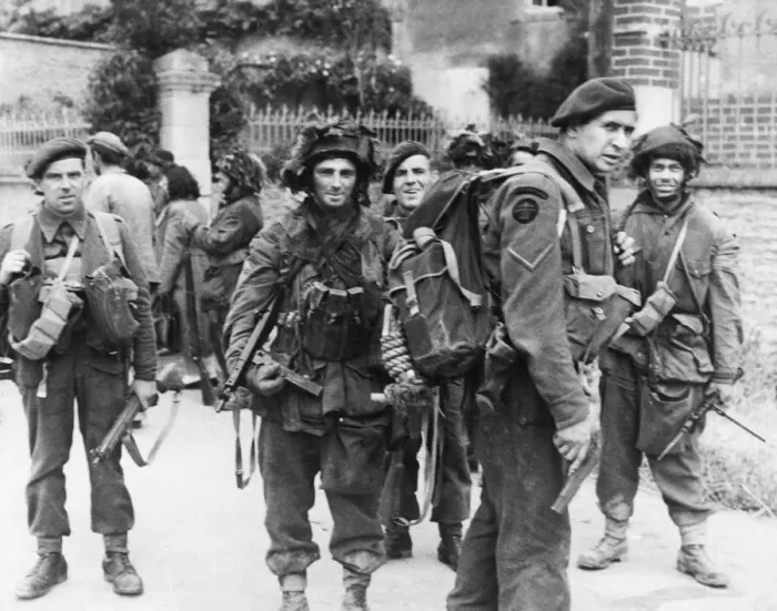 Framed Print : Commandos pause during cleaning up of village during WWII. Circa 1940s Framed Print : Commandos pause during cleaning up of village during WWII. Circa 1940s