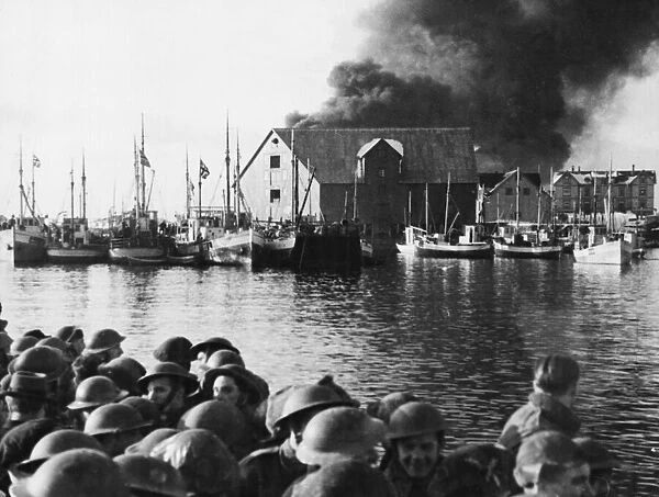 Commandos sail for home as a Stamsund objective burns. Circa 1940s
